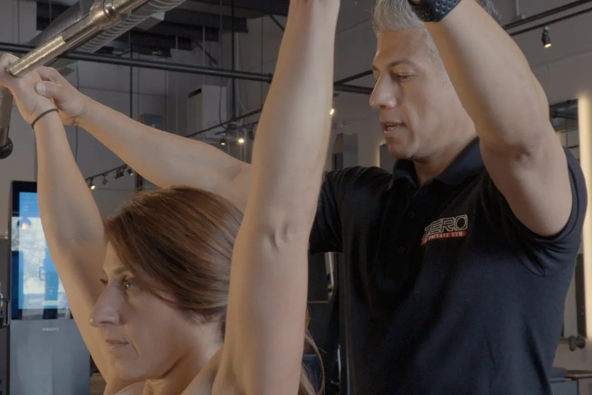 Coach guiding a client through a session at ZERO Training Center